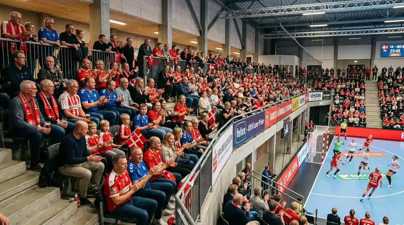 Tilskuere på tribunen til en kvindehåndboldkamp i Danmark